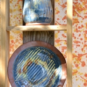 Rustic blue terracotta fruit bowl and flower vase on shelves