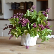 White flower vase with lilac blossoms